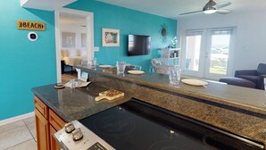 A kitchen with a granite countertop, a built-in stove, and a sign that reads "BEACH". - Beachfront on Pass-A-Grille Beach with Pool! Walking Distance to Great Restaurants and Shops. (St. Pete Beach)