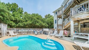 A swimming pool with lounge chairs and a wooden deck. - Duck Haven - Tuckahoe, Easy Walk to Ocean, Pool, Hot Tub, Discounts! (Duck)