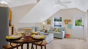 A cozy living room with a dining area, a ceiling fan, a window with a view, and a door with a basket. - **SUZY'S PARROT PERCH @ OLD TOWN** Condo + Last Key White Glove Service... (Key West)