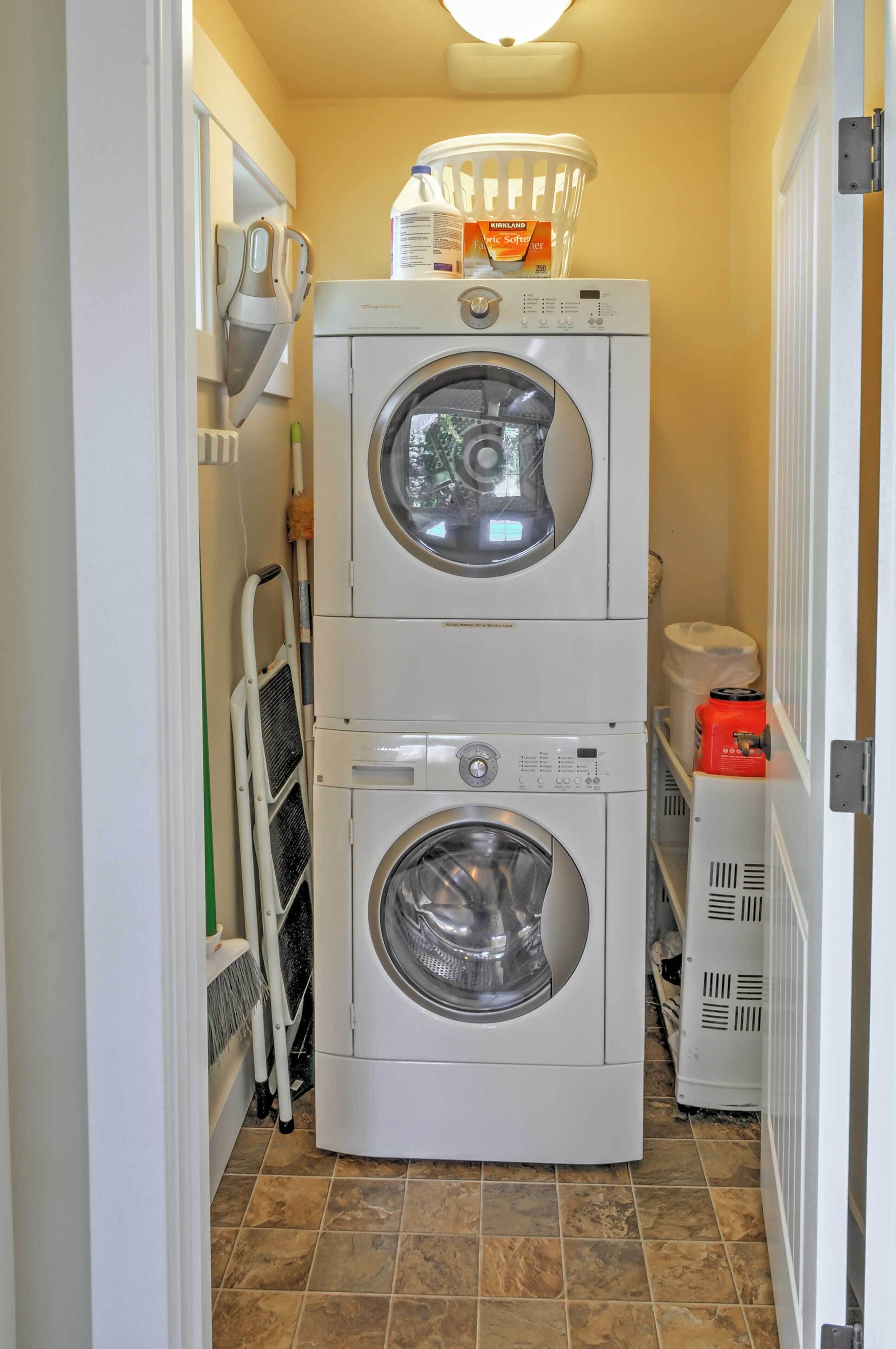 A stacked washer and dryer unit with a detergent box on top.