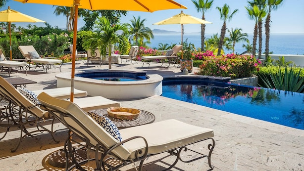 A poolside area with lounge chairs, yellow umbrellas, and a hot tub. - Ocean View 5 BR Luxury Villa Las Brisas Includes Private Pool, Jacuzzi & Wet Bar (San Jose del Cabo)