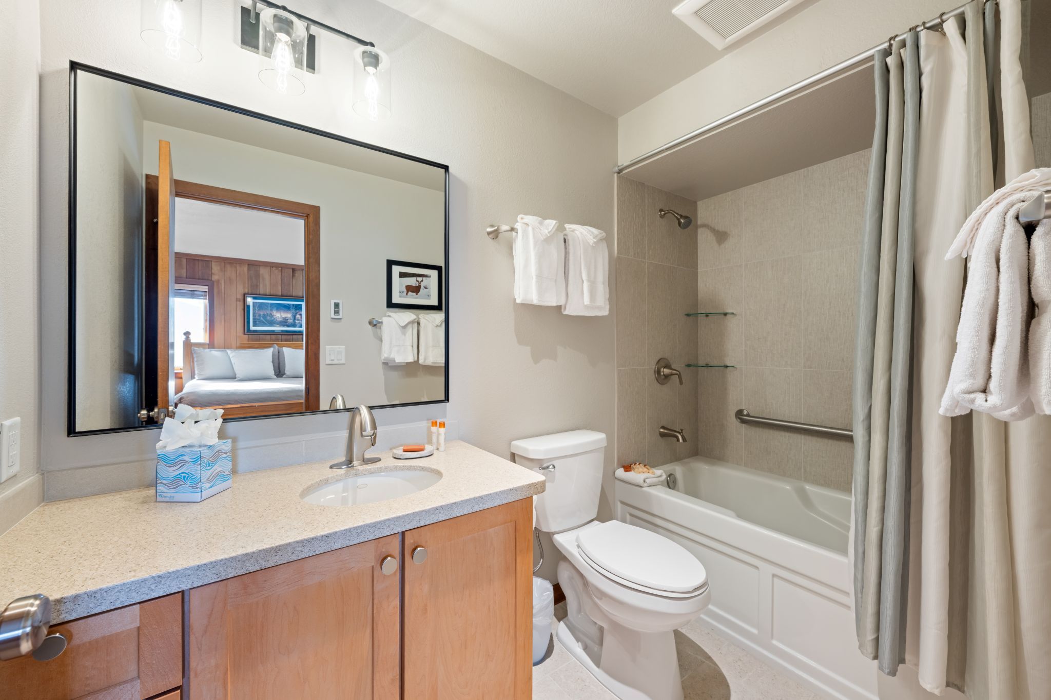 A bathroom with a sink, toilet, and bathtub.