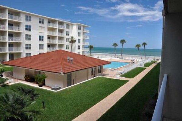 Guests can enjoy stunning views from the hotel's spacious balconies overlooking a well-manicured lawn and pool.