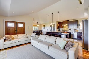 Relax in the spacious living area with a large L-shaped sofa and dining table.