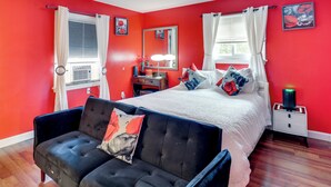A bedroom with a bed, a bedside table, a lamp, a chair, and a nightstand.