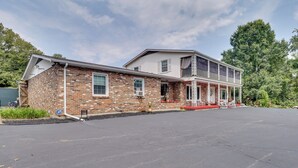 A two-story building with a brick facade and a covered porch.