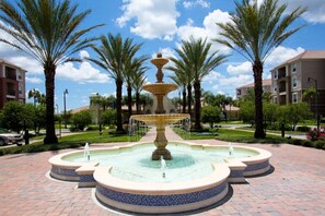Stunning courtyard fountain with a central water feature and brick walkway.