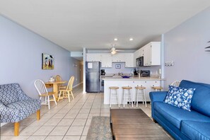 A compact living space with a dining area, kitchen, and seating area.