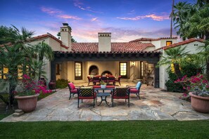 A patio with stone flooring, outdoor furniture, and a fire pit.