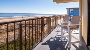 A balcony with a view of the beach and ocean. - Enjoy panoramic views of the beach from the living room, dining room, kitchen and master bedroom. (Ocean City)
