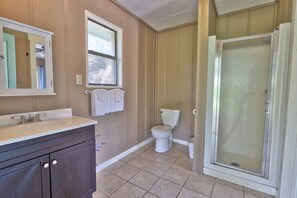 A bathroom with a sink, toilet, and glass shower enclosure. - Your own Private Oasis, pool, hot tub, fire pit on 10 gorgeous acres (Wimberley)
