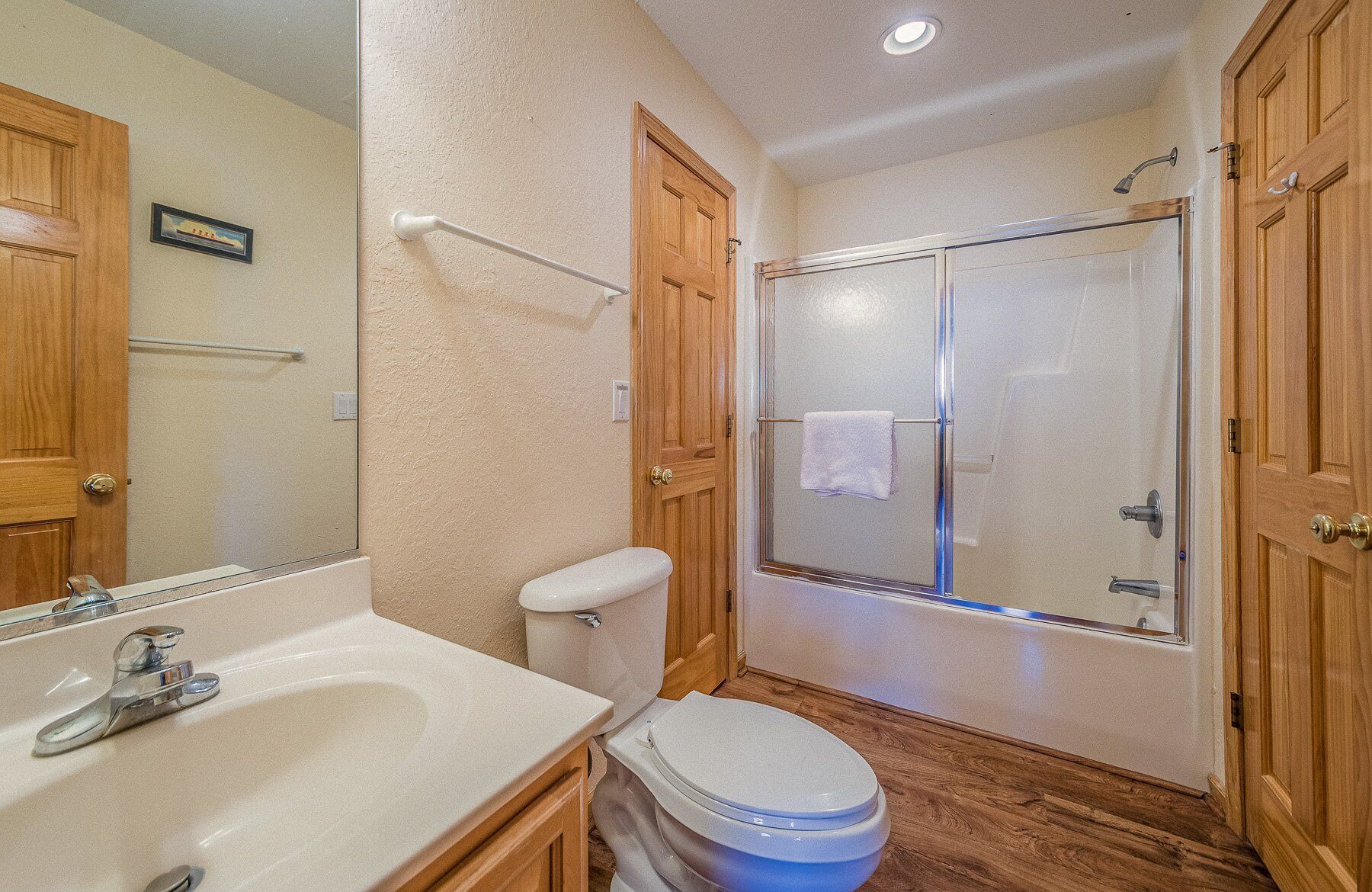 A bathroom with a sink, toilet, and shower.