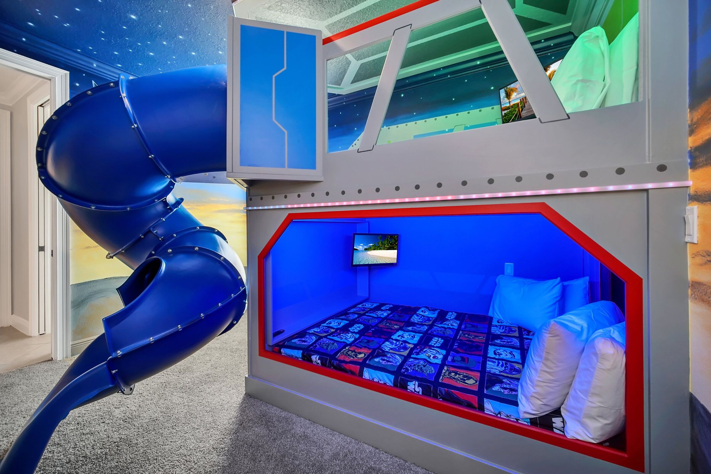 A child's playroom with a slide, a bed with a view, and a TV.