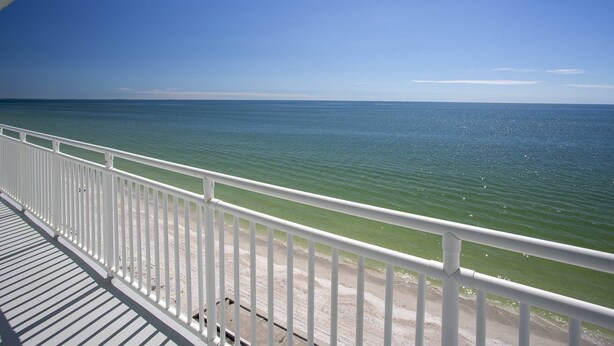 A balcony with a view of the ocean.