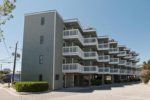 A multi-story building with a flat roof and balconies.
