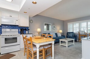 A compact living space with a kitchen, dining area, and seating area.