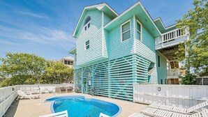 A two-story house with a swimming pool and outdoor seating. - Time to Paws & Reflect - Corolla, Ocean Sands, Ocean View, Beach 260 Yds, Pool, Pets OK, Flex Stays (Corolla)