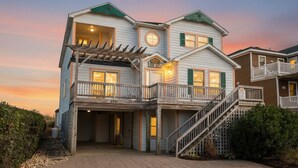 A two-story house with a covered porch, a staircase, and a garage.