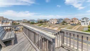 A coastal residential area with houses, a road, and a wooden walkway. - Fun 'N Sun - Nags Head MP 16, 250 Ft to Beach Access, Pool, Pets OK, YR Flex Stays (Nags Head)