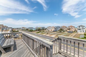 A coastal residential area with houses, a road, and a wooden walkway. - Fun 'N Sun - Nags Head MP 16, 250 Ft to Beach Access, Pool, Pets OK, YR Flex Stays (Nags Head)