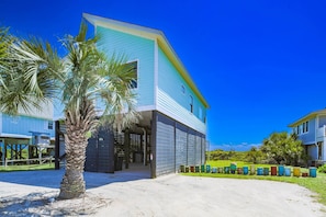 A modern two-story building with a light blue exterior and a covered entrance.
