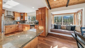 A modern kitchen with wooden cabinets, granite countertops, and a built-in stove. - Heavenly Mountain View: Pool Table, Hot Tub, BBQ (South Lake Tahoe)