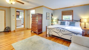 Ein Schlafzimmer mit Bett, Schminktisch und Deckenventilator.