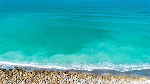 Enjoy breathtaking views of turquoise waters meeting a sandy beach.