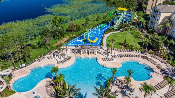 A resort with a large central pool, a water park, and a well-maintained lawn area. - Spacious Kissimmee Villa - 3 Mi to Disney World! (Kissimmee)