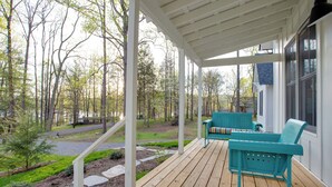 A wooden deck with two teal chairs and a bench, surrounded by a white pergola and a view of a forested area. - Enchanting Andersonville Home Steps to Norris Lake (Andersonville)