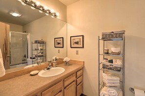 A bathroom with a sink, mirror, and towel rack. - Rustic Home on Whitefish Mountain, Near Ski Run! (Whitefish)