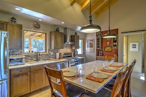 Enjoy cooking and dining in this well-equipped kitchen with a large island, oven, and ample counter space.
