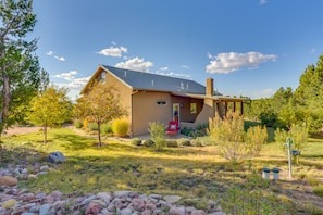 Situated in a lush landscape, this single-story house offers a serene and atmosphere.