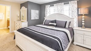 A bedroom with a bed, nightstand, dresser, and a ceiling fan. - Storey Lake Resort home with Mini-Golf & Lazy River | Private Pool | Sleeps 10 (Kissimmee)