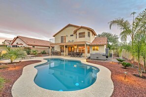 A two-story house with a swimming pool, patio furniture, and a barbecue area. - Hot Tub & Pool: Stunning Goodyear Home Near Lakes (Goodyear)