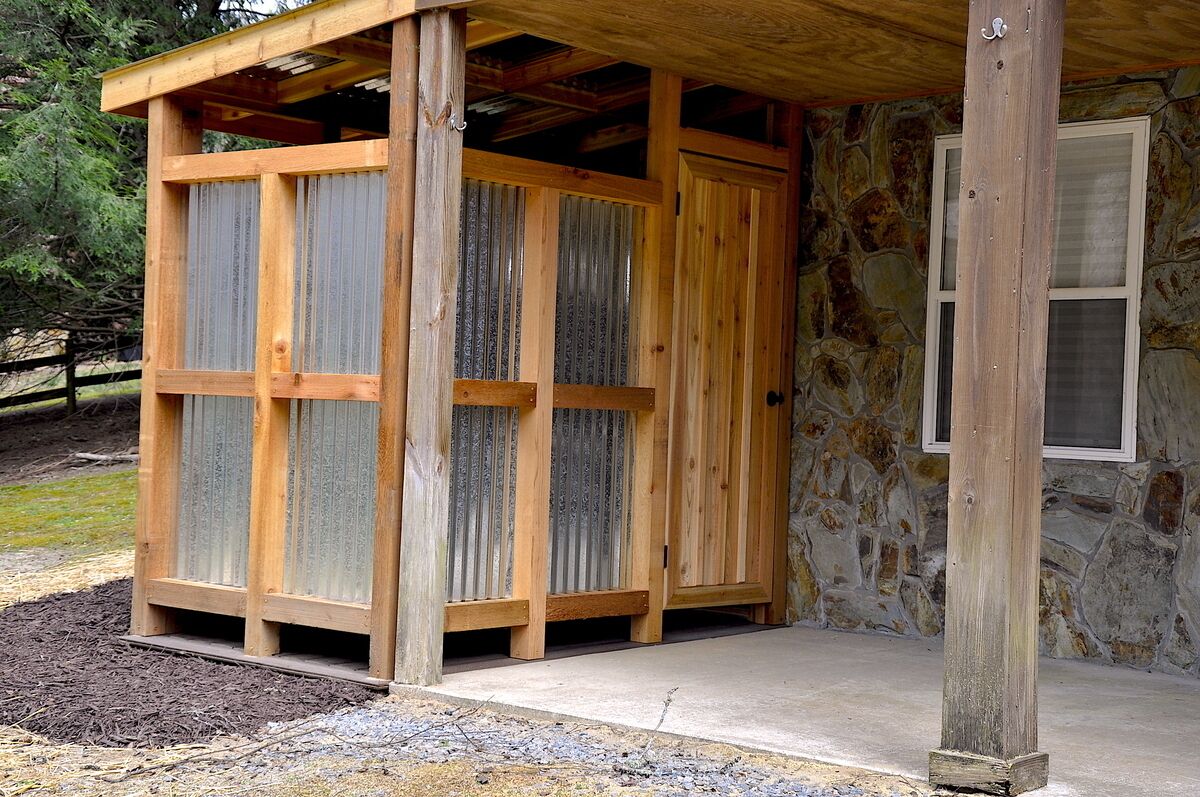 A wooden structure with a stone wall and a window.