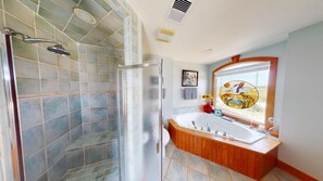 A bathroom with a shower, a bathtub, and a large mirror. - Oceanfront Luxury Pool/Tiki Bar, Game Rm, 3 night stays available July 4th wk (Carova)