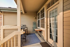 Enjoy a quiet moment in this cozy outdoor space with a table, chairs, and lantern.