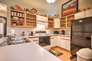 Enjoy cooking in this well-organized kitchen with a central island, oven, and refrigerator.