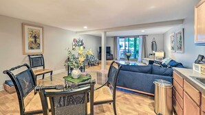 A spacious living area with a sofa, dining table, chairs, and a kitchen area. - Downtown Grand Haven Apt < 1 Mi to Lake Michigan (Grand Haven)