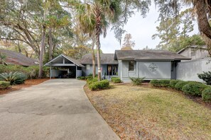 A residential property with a garage, covered porch, and a front yard with trimmed bushes and trees. - 6 Cannon Row: Pet Friendly Home, Free Bikes, Private Pool, Walk to Beach (Hilton Head Island)