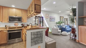 A modern kitchen with stainless steel appliances, wooden cabinets, and a built-in microwave. - Downtown Breckenridge, Garage Parking! (Breckenridge)