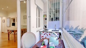 A kitchen with a window, a dining table with chairs, and a bookshelf. - Rome, near Piazza di Spagna, cozy apartment for 6  (Rome)
