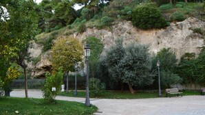 A paved walkway in a park with benches and lamp posts. - Detached apartment (Salerno)