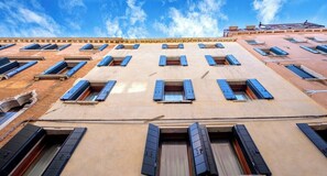A multi-story building with a row of windows on each floor.