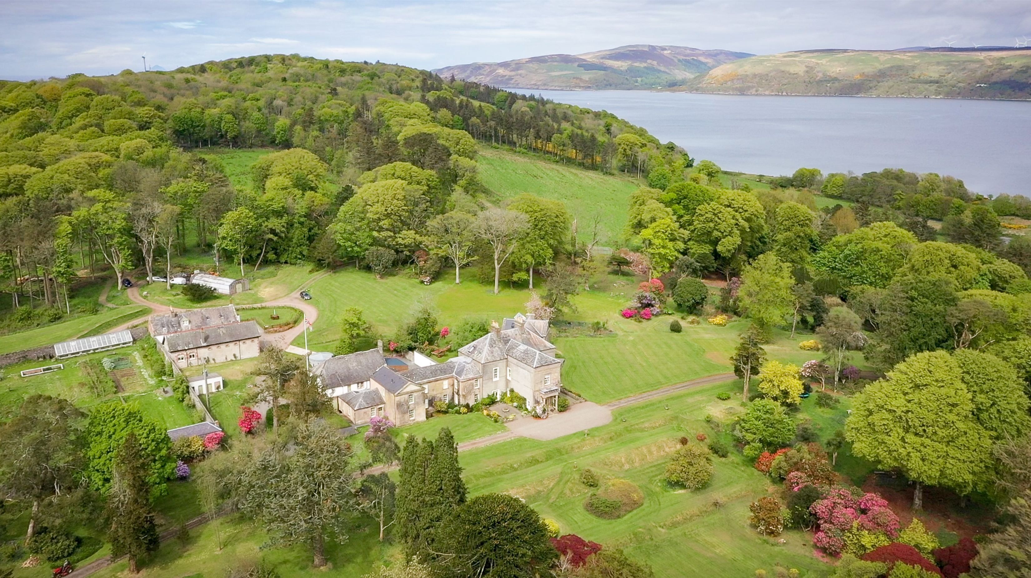 A large estate with a main house, several smaller buildings, and extensive gardens.