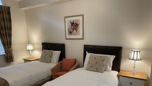 A hotel room with two single beds, a headboard, bedside tables with lamps, a framed picture on the wall, and a window with curtains. - Stay somewhere unusual , Peaceful central location, sleeps 4, Pets Welcome. (Perth)