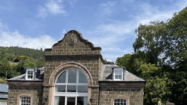 A stone building with a large arched entrance, a clock above the door, and a picnic table outside. - Stay somewhere unusual , Peaceful central location, sleeps 4, Pets Welcome. (Perth)