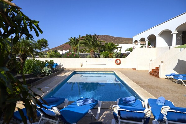 A heated pool, sun loungers