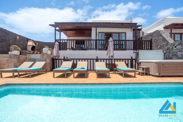 A heated pool, sun loungers